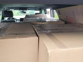 Image of boxes containing cannabis inside vehicle. /