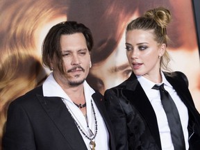 Actors Johnny Depp (L) and Amber Heard attend the Los Angeles Premiere of "The Danish Girl", in Westwood, California, on November 21, 2015.