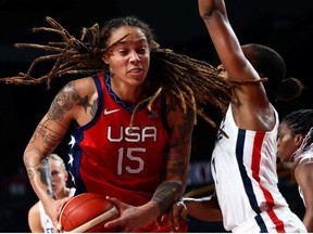 FILE: Brittney Griner of the United States in action with Sandrine Gruda of France at Saitama Super Arena during their Tokyo 2020 Olympic women's basketball Group B game in Saitama, Japan Aug. 2, 2021.