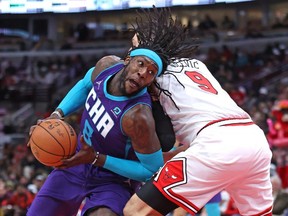 Montrezl Harrell #8 of the Charlotte Hornets drives around Nikola Vucevic #9 of the Chicago Bulls at the United Center on April 08, 2022 in Chicago, Illinois.