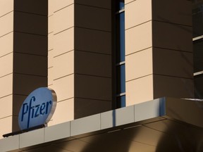 FILE: A sign for Pfizer pharmaceutical company is seen on a building in Cambridge, Massachusetts, on March 18, 2017.