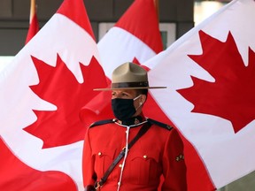 FILE: A Royal Canadian Mounted Police officer stands guard outside the Senate of Canada prior to the Speech from the Throne September 23, 2020 in Ottawa, Canada.