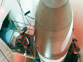FILE: This U.S. Air Force handout file image shows an Air Force technician inspecting an LGM-30G Minuteman III missile inside a silo about 60 miles from Grand Forks Air Force Base, in North Dakota. /