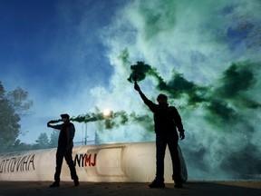 WASHINGTON, DC - OCTOBER 27: Cannabis advocates deploy green smoke and a fake inflatable joint outside the Russian Embassy to demand the release of American basketball star Brittney Griner.