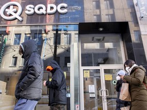 People walk by an SQDC (Société québécoise du cannabis) store in Montreal.