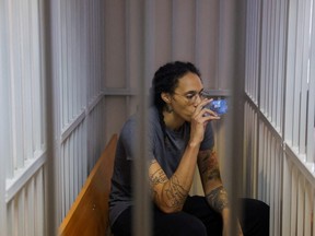 FILE - U.S. basketball player Brittney Griner, who was detained at Moscow's Sheremetyevo airport and later charged with illegal possession of cannabis, drinks water inside a defendants' cage after the court's verdict in Khimki outside Moscow, Russia August 4, 2022.