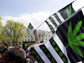 FILE - A demonstrator waves a flag with marijuana leaves depicted on it during a protest calling for the legalization of marijuana, outside of the White House on April 2, 2016, in Washington. President Joe Biden is pardoning thousands of Americans convicted of "simple possession" of marijuana under federal law, as his administration takes a dramatic step toward decriminalizing the drug and addressing charging practices that disproportionately impact people of color.