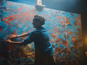 A woman creating colourful art