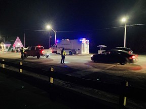 Police officers check vehicles at a checkpoint set up at the Foxtrap Weigh Scales in Newfoundland.