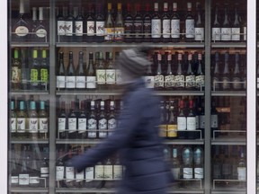 Manitoba's plan to expand private liquor sales may not happen before the provincial election slated for Oct. 3. A person walks past shelves of bottles of alcohol on display at an outlet in Ottawa on Thursday, March 19, 2020.