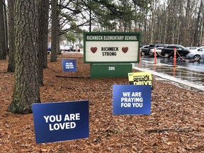 FILE - Signs stand outside Richneck Elementary School in Newport News, Va., Jan. 25, 2023. The mother of a 6-year-old boy who shot his teacher at the Virginia school is expected to plead guilty in federal court Monday, June 12, 2023, to using marijuana while possessing a firearm, which is illegal under U.S. law.