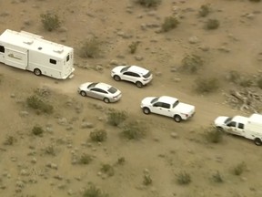 FILE - This aerial still image from video provided by KTLA shows law enforcement vehicles where several people were found shot to death in El Mirage, Calif., Wednesday, Jan. 24, 2024. Prosecutors filed murder charges Tuesday, Jan. 30, 2024, against five suspects in the fatal shootings of six men at a remote dirt crossroads in the Southern California desert after what investigators said was a dispute over marijuana. (KTLA via AP, File)