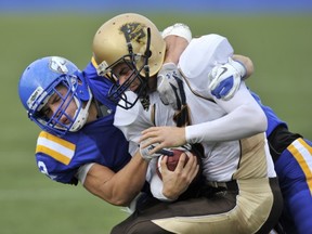 UBC freshman defensive back Adam Konar (left) puts the heat on Manitoba quarterback Khaleal Williams on Saturday. (Jason Payne, PNG Photo)