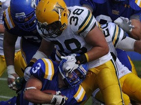 UBC running back Dave Boyd gets prime attention from Alberta on Saturday at Thunderbird Stadium. (Jenelle Schneider, PNG photo)