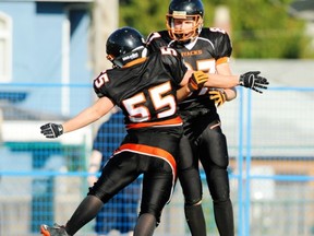 Hyacks Jeremy Wilson (facing) and linebacker Jordan Chin opened the 2011 season Friday in Californa. (PNG photo)