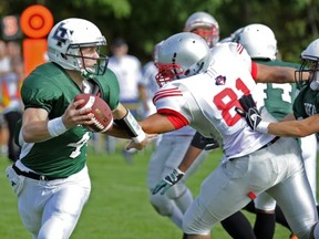 Lord Tweedsmuir quarterback Mike Messenger eludes the Holy Cross pass rush Friday in Surrey. (Les Bazso, PNG)