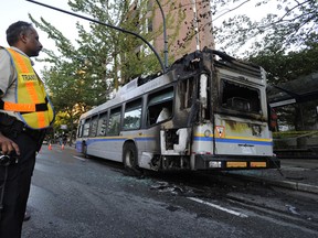 Transit Supervisor, Bal Mann, with Coast Mountain Bus Company, looks over the remains of this bus after it caught on fire on Burrard St. near Pacific Avenue Friday afternoon in Vancouver, September 9, 2011.