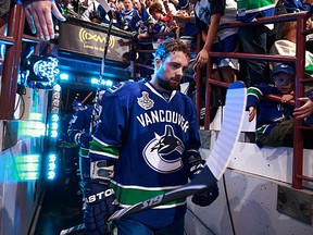 Dan Hamhuis walks to the ice during Game One of 2011 NHL Stanley Cup Finals against the Boston Bruins at Rogers Arena on June 1, 2011 in Vancouver, British Columbia, Canada. (Photo by Jeff Vinnick/NHLI via Getty Images)