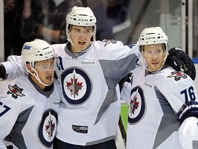 Winnipeg Jet Mark Scheifele (middle) celebrates his third period goal against the Vancouver Canucks with team mates Jason Gregoire (left) and Shayne Wiebe (right) at the 2011 Young Stars Tournament held in Penticton on September 15, 2011. The Vancouver Canucks, Calgary Flames, Edmonton Oilers, Winnipeg Jets and San Jose Sharks prospects teams are participating in the tournament. (Photo by Larry Wong/Edmonton Journal/Postmedia News Service)