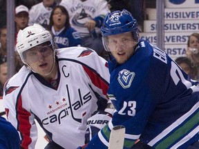 Canucks' Ales Edler (right) keeps Alex Ovechkin in check after Ovechkin's shot on Roberto Luongo Saturday night at Rogers Arena. (Rich Lam/Getty Images)