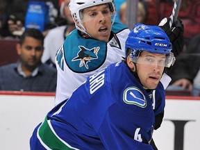 VANCOUVER — Keith Ballard of the Canucks battles for position with Joe Pavelski of the San Jose Sharks on Sept. 25 at Rogers Arena.  (Photo by Nick Didlick/Getty Images) *