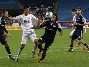 Caps' Long Tan fights for the ball against the New England Revs earlier this season. (Gail Oskin/Getty Images)