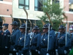 This is what they do in Boston. State troopers march with hockey sticks. Make hockey, not war.