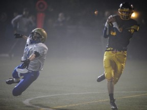 Hugh Boyd's Daniel Chernov (right) hauls in the game's opening score Friday behind Seaquam's Keegan Lensink during South Conference 2A league action in Richmond. Boyd won 14-13 in overtime. (Ric Ernst, PNG photo)