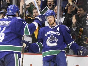 Daniel Sedin is joined by Alex Burrows in celebrating his opening goal Thursday night against the Nashville Predators in a 5-1 Canucks win.