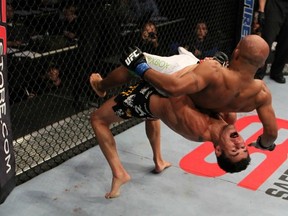 Bantamweight champion Dominick Cruz suplexes challenger Demetrious Johnson during last night's main event. (photo courtesy of Josh Hedges/Zuffa LLC)