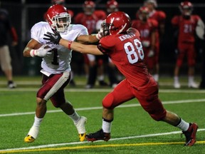 Mouat's Devin Logan (left) tries to break past STM's Dante Vigini on Friday at Burnaby Lakes. (Steve Bosch, PNG)