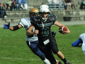 Mission quarterback Kevin Wiens feels the rush from the Rick Hansen Hurricanes. (Sports Action Photography)