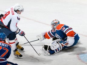 EDMONTON, CANADA - OCTOBER 27: Nikolai Khabibulin #35 of the Edmonton Oilers pokechecks the puck from Alex Ovechkin #8 of the Washington Capitals at Rexall Place on October 27, 2011 in Edmonton, Alberta, Canada. (Photo by Andy Devlin/NHLI via Getty Images)
