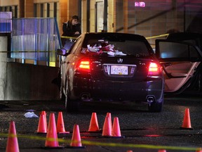 Police investigate a shooting scene at the King George Centre shopping mall at 100th Avenue and King George Boulevard in Surrey, B.C. October 22, 2011. (Ric Ernst/PNG)