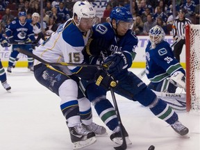 Alex Sulzer battles for the puck with Jamie Langenbrunner of the Blues on Wednesday night at Rogers Arena.