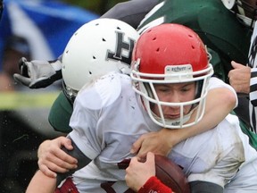 W.J. Mouat's Taylor Hinton is tackled by the Lord Tweedsmuir Panthers on Friday in Surrey. (Ric Ernst, PNG)