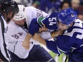 EDMONTON - Aaron Volpatti of the Canucks exchanges blows with Jake Taylor of the Oilers during a Sept. 22 preseason game in Edmonton.  (Photo by Rich Lam/Getty Images)