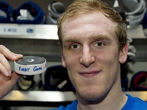 VANCOUVER — A picture tells a 1,000 words. Canucks winger Dale Weise poses with puck after scoring his first NHL goal Thursday against Nashville. (Jeff Vinnick, National Hockey League).