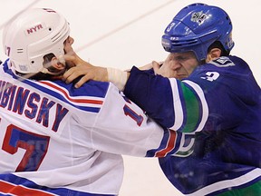Vancouver Canucks Kevin Bieksa (R) and  New York Rangers Brandon Dubinsky(L)  fight in third period regular season NHL action at Rogers Arena, Vancouver,October 18 2011. Gerry Kahrmann  /  PNG staff photo)