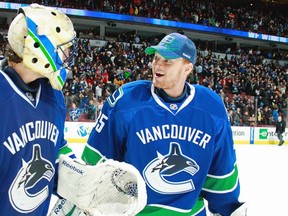 VANCOUVER, CANADA - MARCH 14:  Roberto Luongo #1 of the Vancouver Canucks is congratulated by teammate Cory Schneider #35 after their game against the Minnesota Wild at Rogers Arena on March 14, 2011 in Vancouver, British Columbia, Canada. The Canucks won 4-2. (Photo by Jeff Vinnick/NHLI via Getty Images)