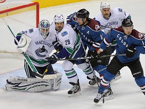 Canucks goalie Cory Schneider contends with traffic Wednesday night against the Avalanche. (Doug Pensinger/Getty Images)