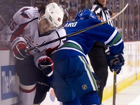 VANCOUVER — Keith Ballard puts a hip into Mathieu Perreault of the Washington Capitals during Oct. 29 meeting at Rogers Arena.  (Photo by Rich Lam/Getty Images)