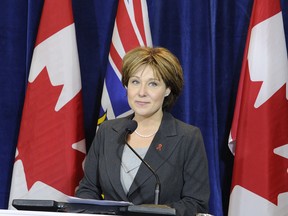 Premier Christy Clark joins several Canadian and B.C. flags in announcing something or other about the latest issue she’s been told the public is fed up about. NICK PROCAYLO — PNG FILES