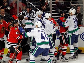 CHICAGO - MARCH 05:  A melee breaks out between the Chicago Blackhawks and the Vancouver Canucks in the first minute of play after Andrew Ladd of the Blackhawks and Ryan Kesler of the Canucks start a fight at the United Center on March 5, 2010 in Chicago, Illinois. (Photo by Jonathan Daniel/Getty Images)