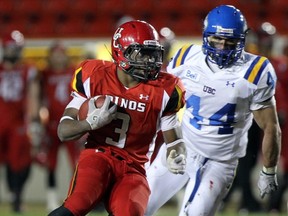 Calgary's Steve Lumbala is chased by UBC's Alex Babalos on Friday at McMahon Stadium in the Hardy Cup final. (Calgary Herald photo)