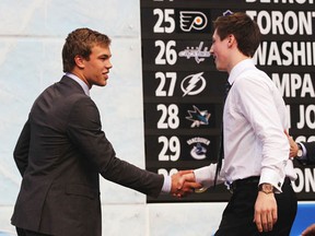 Ryan Nugent-Hopkins (right) gets a handshake from Taylor Hall after becoming the Oilers' No. 1 pick in the 2011 entry draft. Hall was first in 2010. (Bruce Bennett/Getty Images)