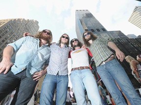 Musicians Ewan Currie, Sam Corbett, Leot Hanson and Ryan Gullen of The Sheepdogs pose in Times Square with their Rolling Stones cover on a building behind them celebrating Rolling Stone's Do You Wanna be a Rock and Roll Star?&ampquot; cover reveal in Times Square on August 1, 2011 in New York City.  (Photo by Michael Loccisano/Getty Images)