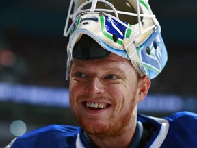 VANCOUVER — Cory Schneider was all smiles in backstopping an overtime victory over Minnesota on Oct. 22 at Rogers Arena. (Photo by Jeff Vinnick/NHL via Getty Images)