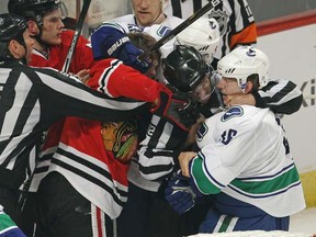 Referees tries to break up an altercation between Michael Frolik (L) of the Chicago Blackhawks and Jannik Hansen of the Vancouver Canucks at the end of Game 3 of the Western Conference Quarterfinals. (Jonathan Daniel/Getty Images)