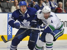 Keith Ballard, seen here battling for the puck with the Leafs Mikhail Grabovski, returns for the first time since suffering back spasms after a Dec. 17 game at Toronto.